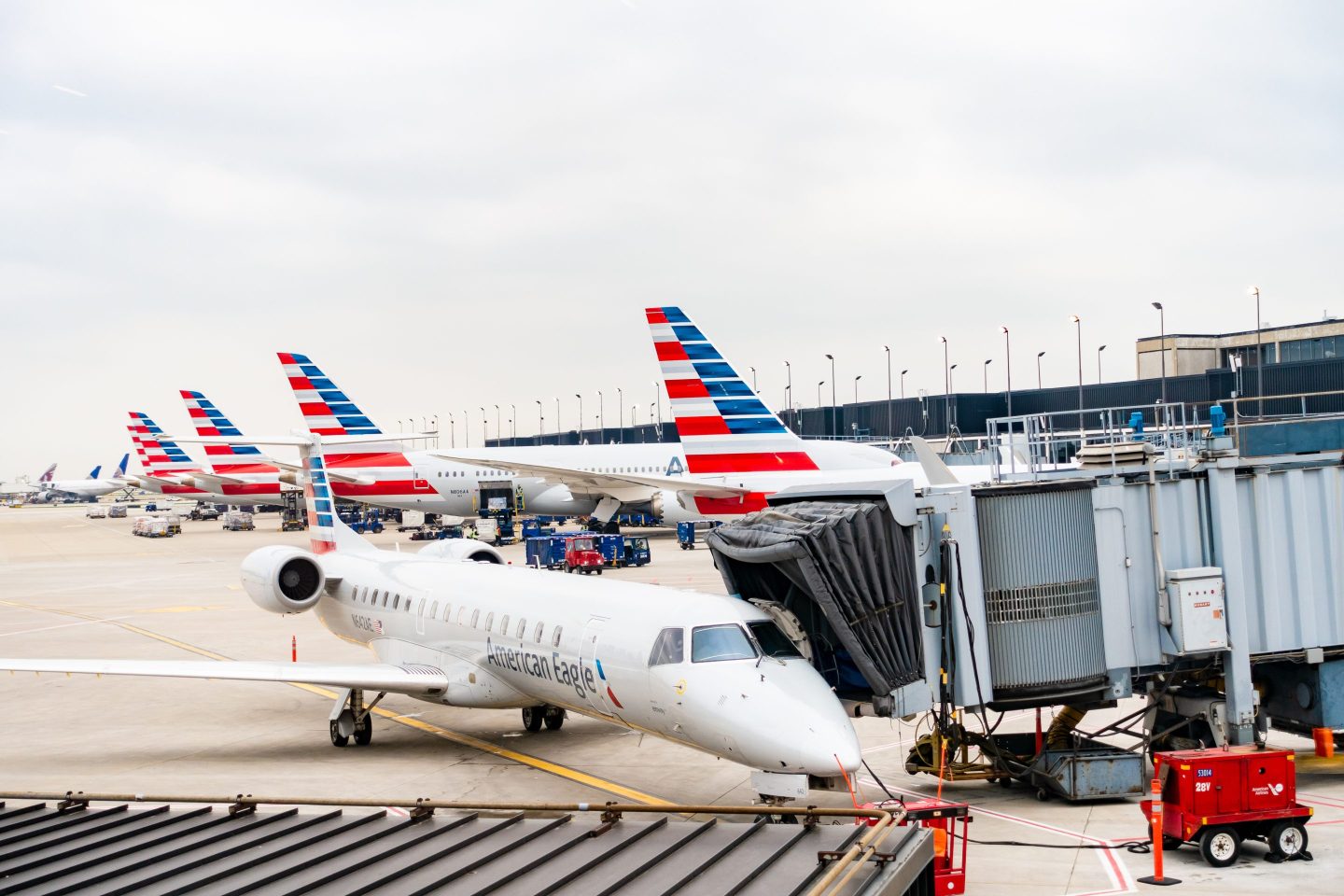 American Airlines planes finishing up for take-off at gate.