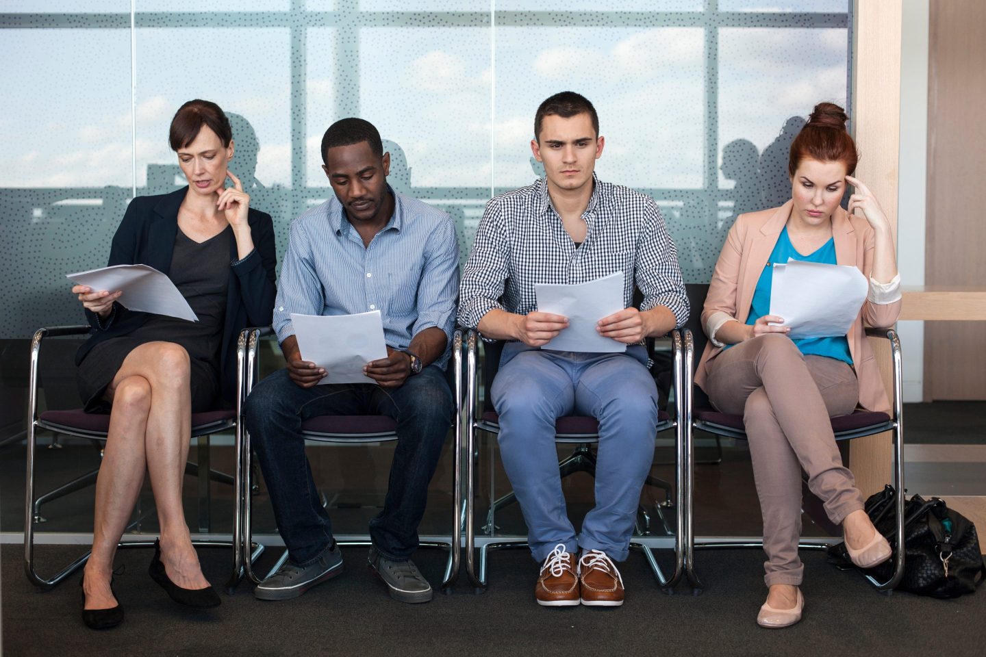 Four people sit in a waiting room