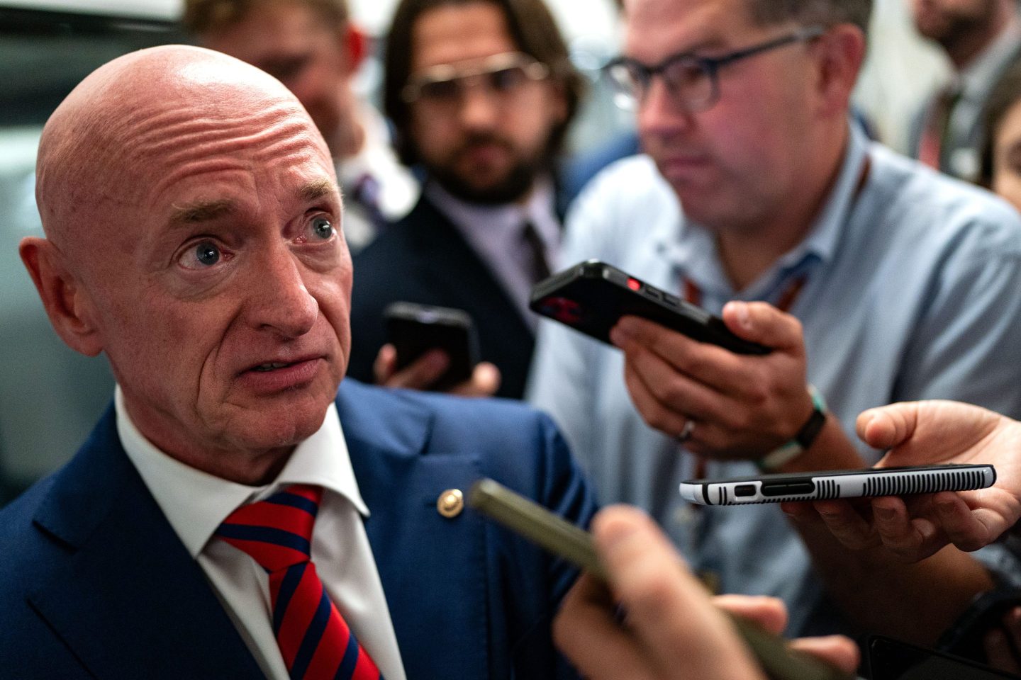 WASHINGTON, DC &#8211; JULY 25: U.S. Sen. Mark Kelly (D-AZ) speaks with reporters while waiting to catch the Senate subway to the Hart Senate Office Building from the U.S. Capitol on July 25, 2024 in Washington, DC.  Multiple news outlets are reporting that the Senator from Arizona and former astronaut is one of many candidates being vetted to be the Vice Presidential running mate to Kamala Harris. (Photo by Kent Nishimura/Getty Images)