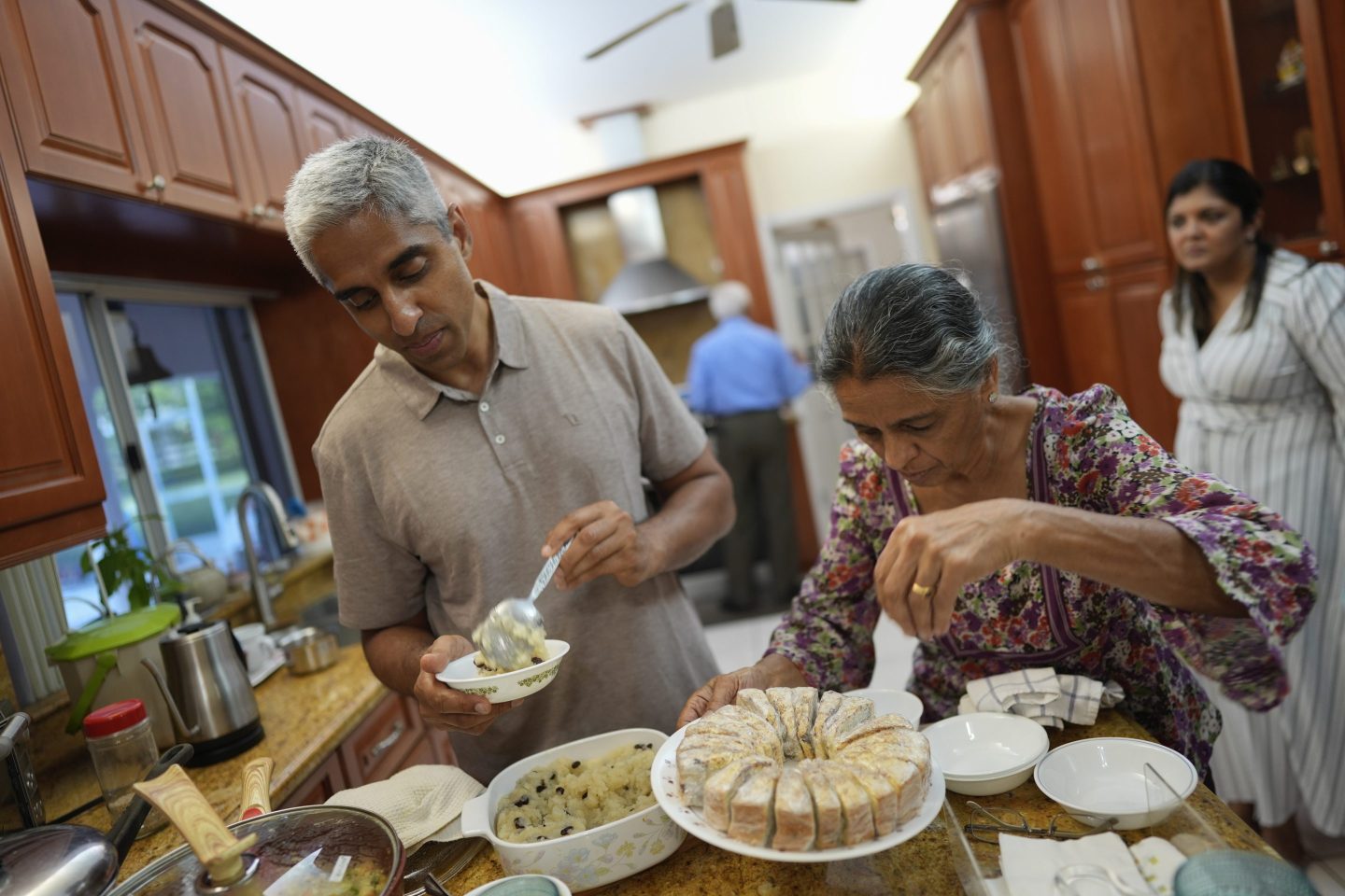 Vivek Murthy and his mom serve food