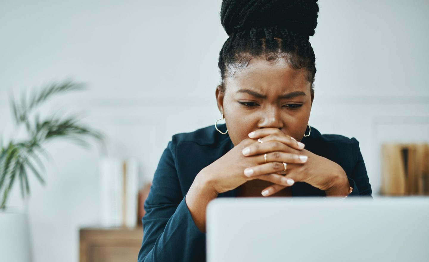 Woman frowns at computer screen