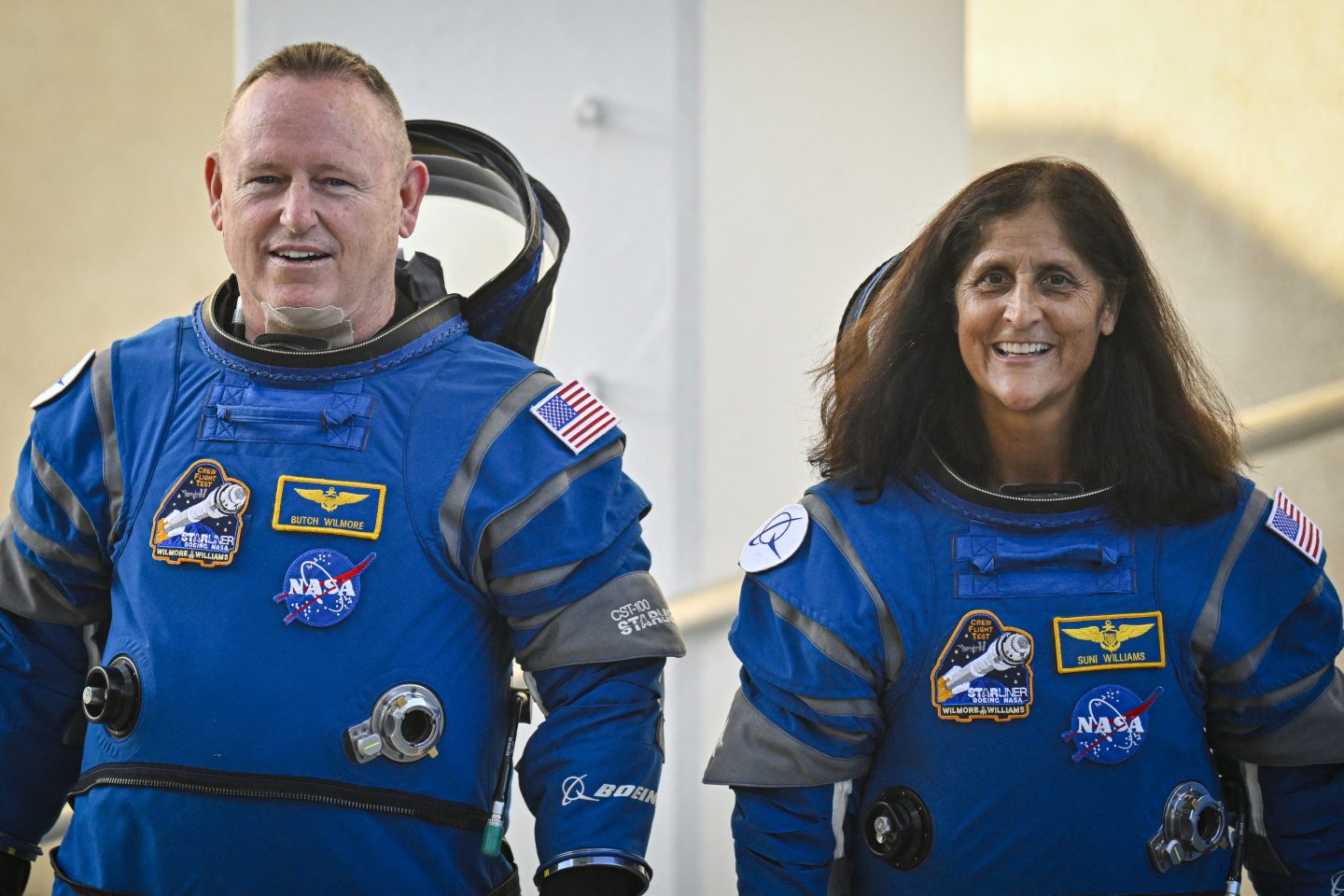 Man and woman astronaut in blue space suits