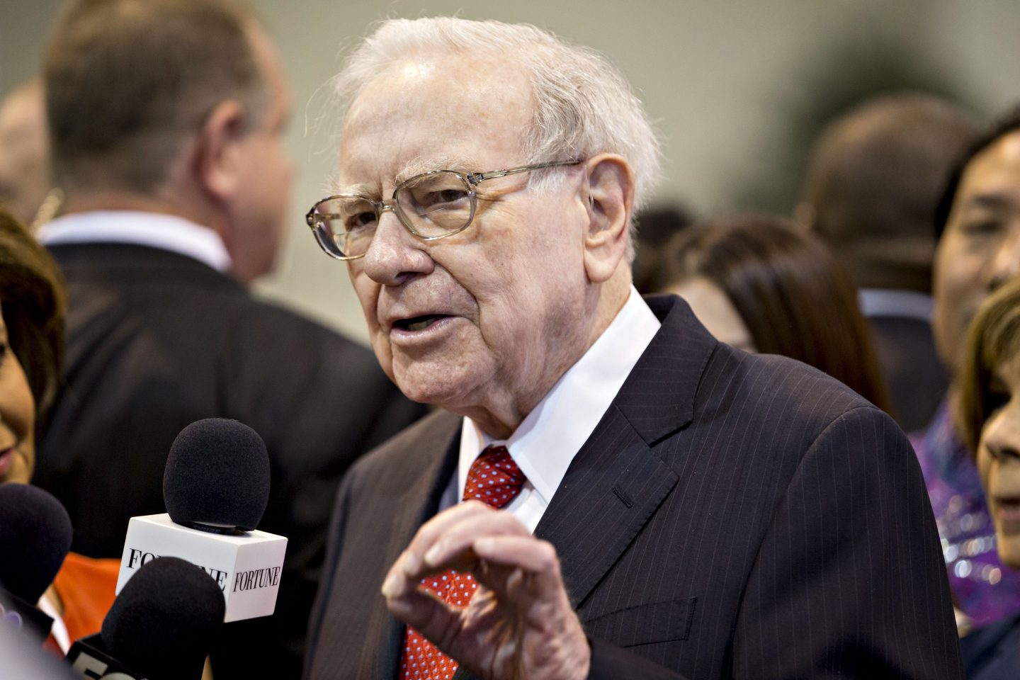 Warren Buffett speaks into microphone