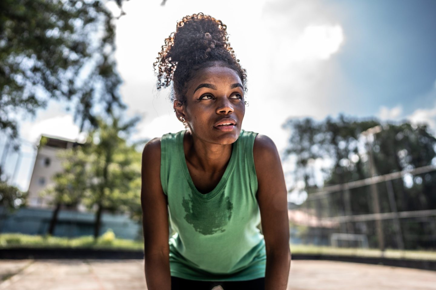 Tired young woman in a sports court