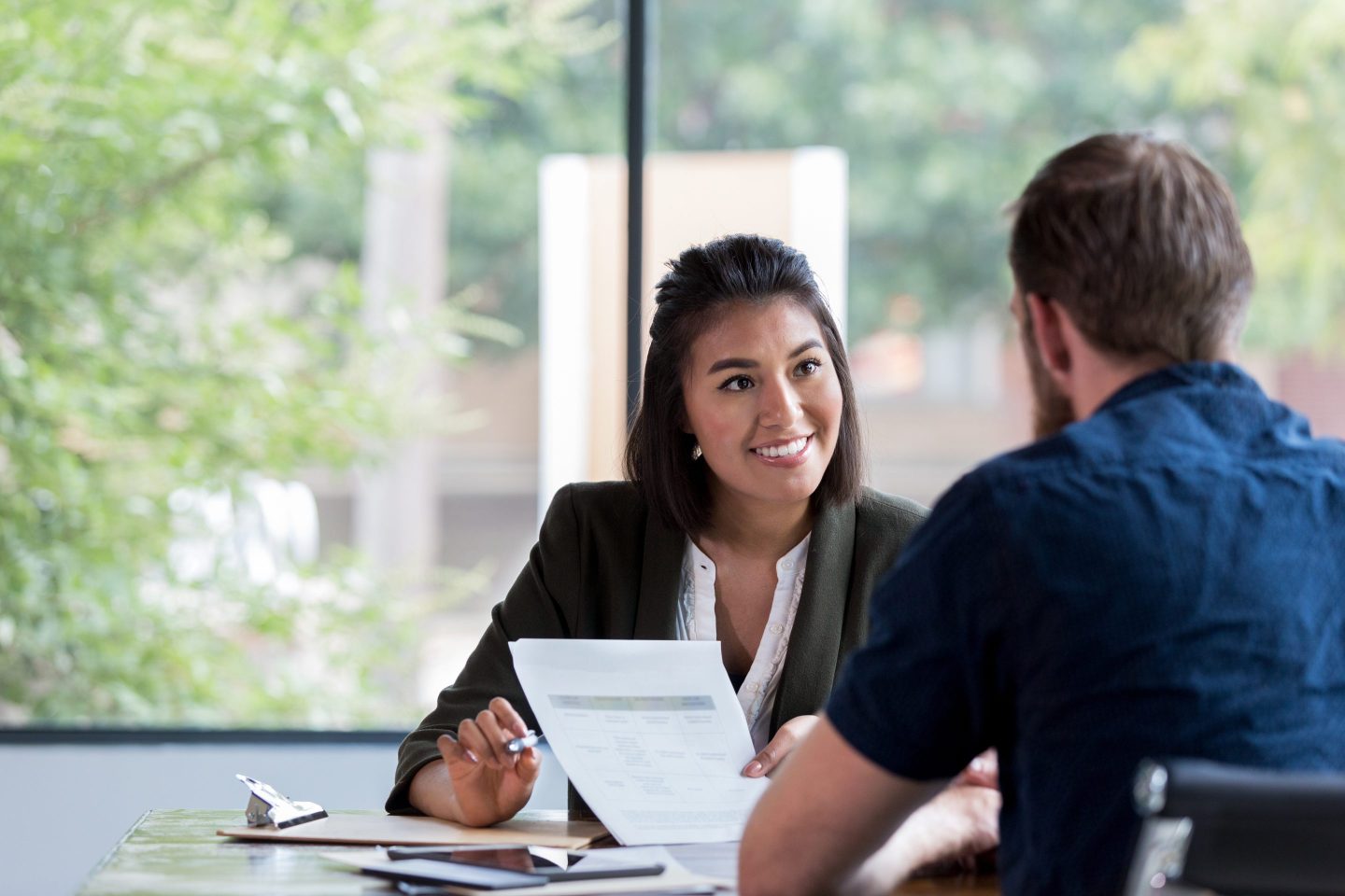 Cheerful businesswoman meets with client.