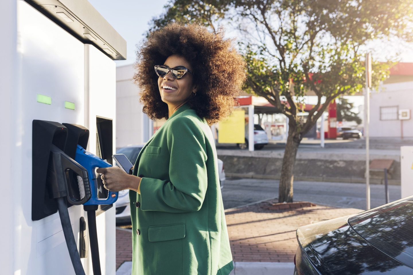 happy woman at fuel pump