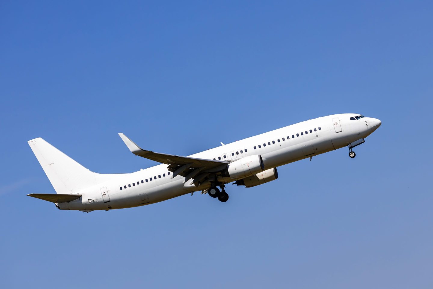 White passenger aircraft in the blue sky