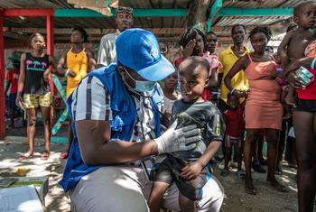 Local displaced and homeless Haitians gather for free medical treatment at an IOM mobile clinic in Place Clercine in Tabarre, Port-au-Prince.