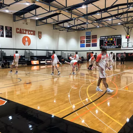 Mens Basketball players warm up on the Braun Gymnasium court