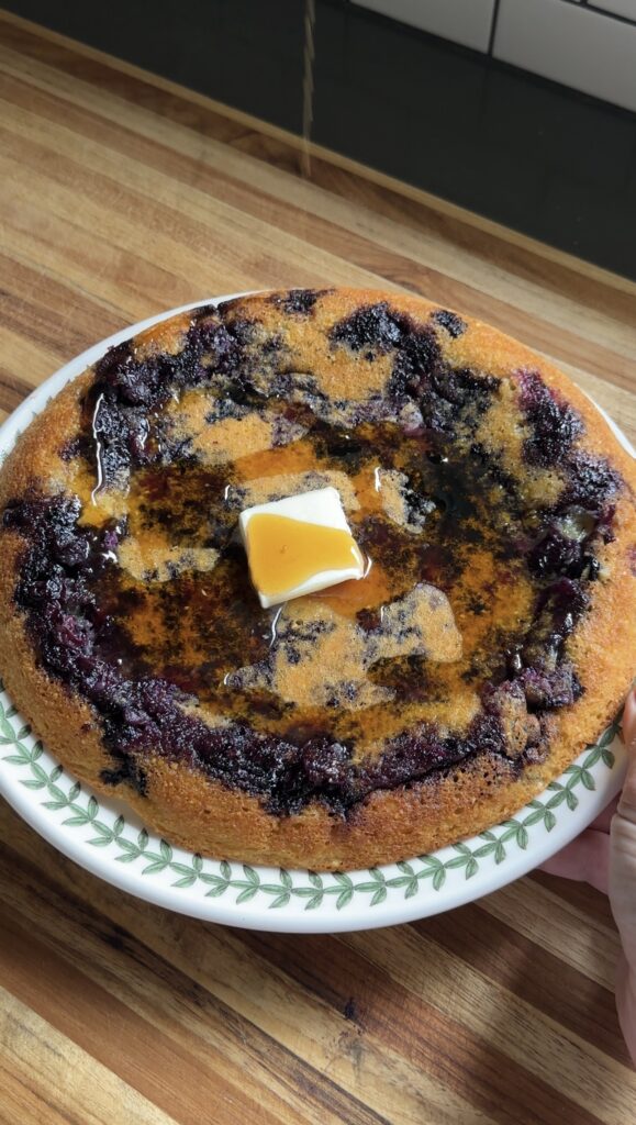 giant cottage cheese blueberry pancake with a pat of butter on top