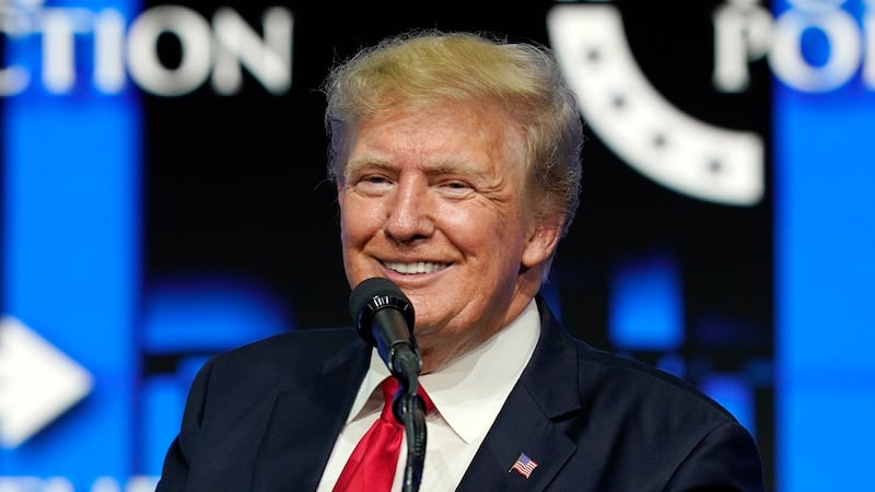 FILE - In this July 24, 2021 file photo, former President Donald Trump smiles as he pauses...