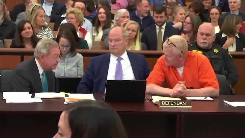 Alex Murdaugh (right) sits at a courtroom table with his defense attorneys, Jim Griffin...