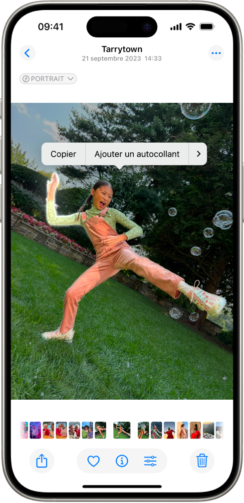 L’app Photos est ouverte sur la photo d’une personne. La personne est sélectionnée, et l’option « Ajouter des autocollants » est disponible dans le menu situé au-dessus.