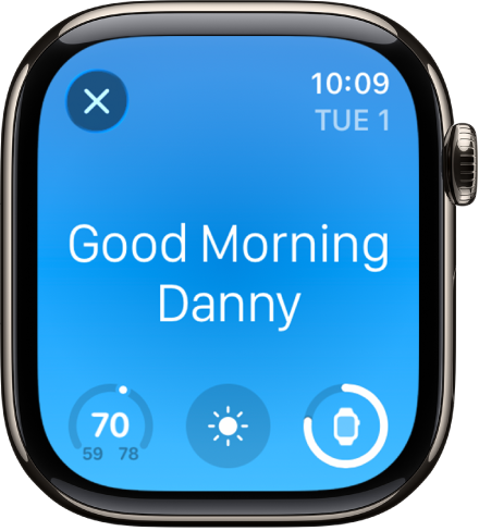 Apple Watch zeigt die Begrüßung beim Aufwachen. Oben wird „Guten Morgen“ angezeigt. Die Temperatur, die Wetterkonditionen und der Batterieladestand werden darunter angezeigt.