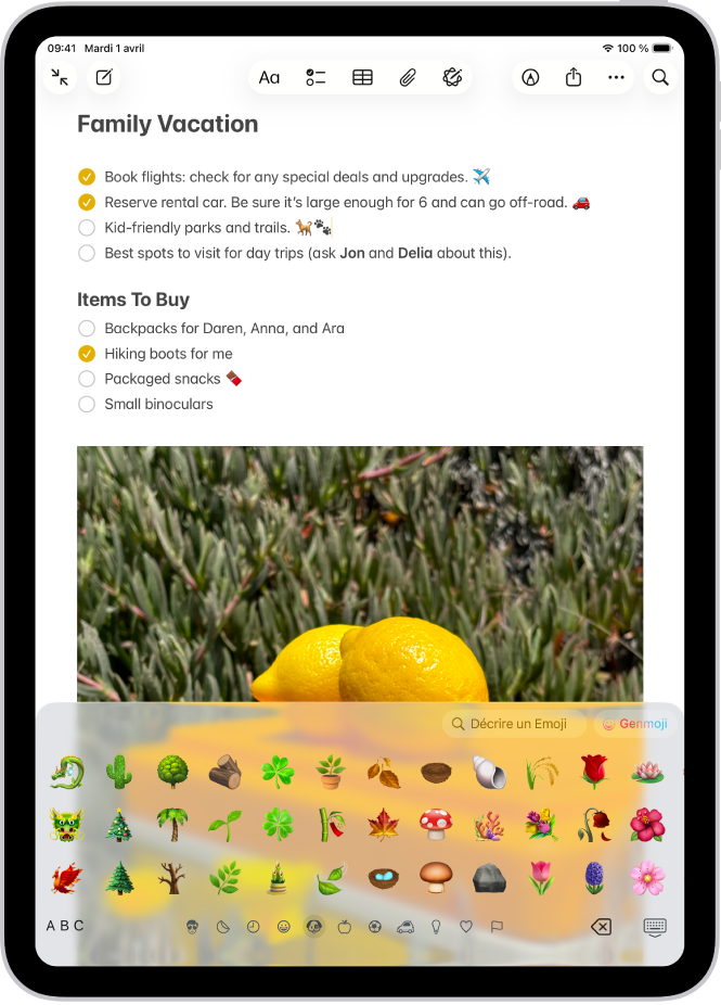 Une note est ouverte dans l’app Notes en haut de l’écran et le clavier des Emoji est ouvert en bas.