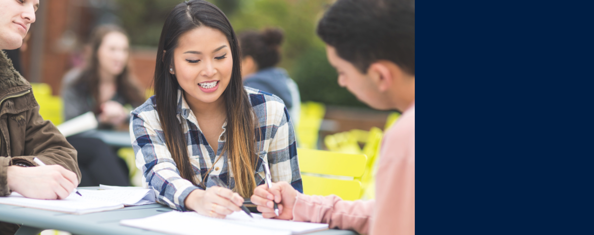 Students sitting at registration table