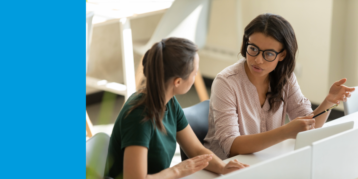 Woman sitting with college student in discussion