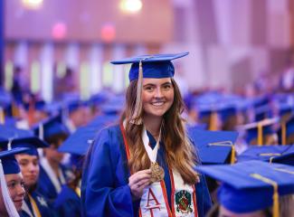 Student showing off medal