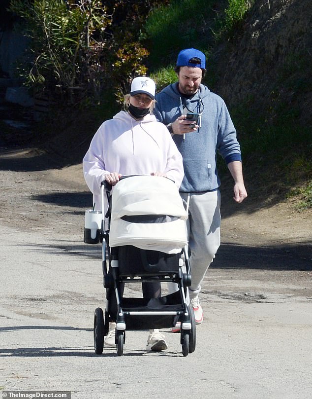 Don't sweat it: Stassi and her husband were dressed down for their stroll, yet adequately protected from the March chill in their sweats