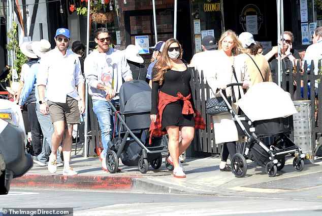 Cozy: Stassi was also dressed in all black, but she covered up against the sea breeze with a stylish cream-colored coat that reached down to her knees