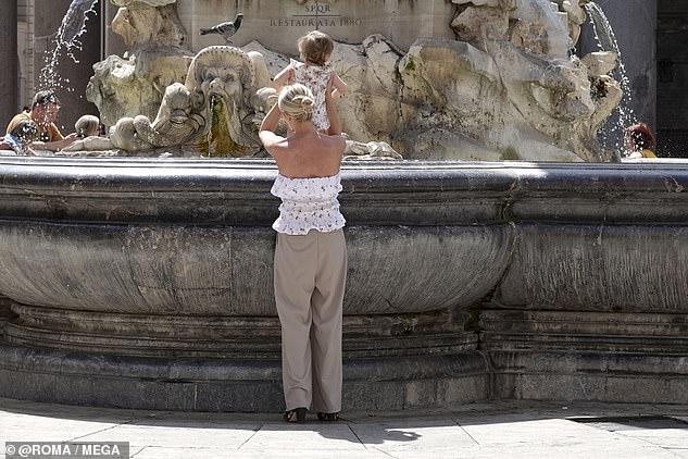 Looking good! Stassi stepped out on a beautiful spring day in Italy wearing a flouncy floral strapless top paired with wide leg khaki slacks and low stacked heels