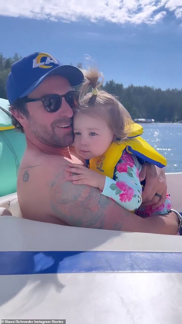 Adorable: The father and daughter were seen sharing some kisses and cuddling while the boat sped across the waves in another clip