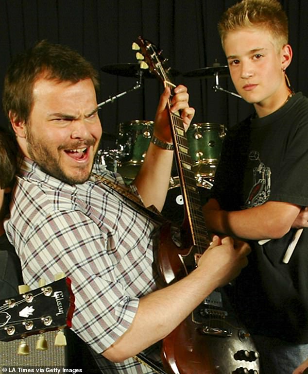 Kevin Clark is seen posing in a promotional picture as Black plays the guitar