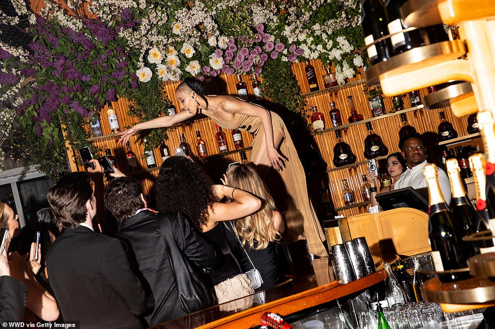 The actress brought the party as she stood on a table near the bar