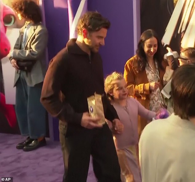 Lea held hands with her famous father at the film premiere