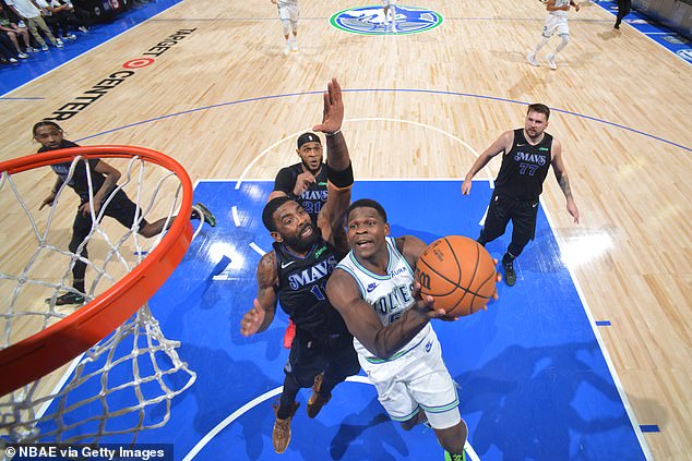 Dallas' Kyrie Irving attempts to block an Anthony Edwards layup attempt in Minneapolis