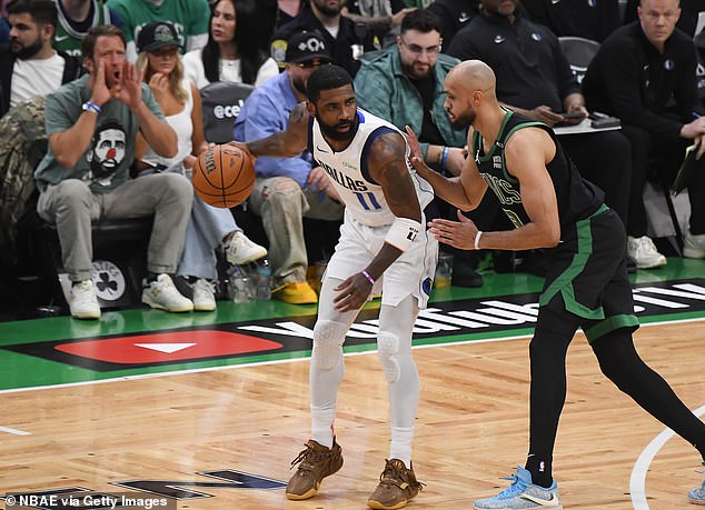 Portnoy, 47, pictured booing in the background while Irving controls the ball in the game