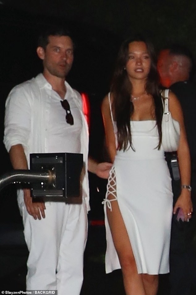 Tobey Maguire's ex-wife Jennifer Meyer, 47, appears to have pushed back on rumors the Spider-Man actor, 49, is in a romance with model Lily Chee, 20. Pictured at a July 4 bash known as the 'White Party' in the Hamptons in New York