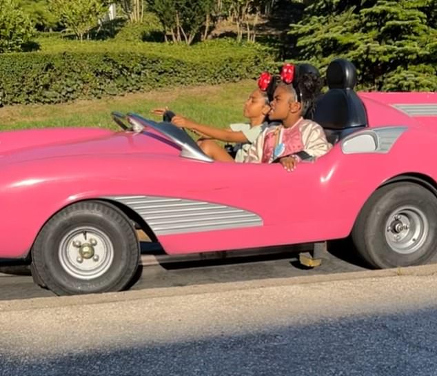 The star - who sparked speculation she is expecting their third child in June - also visited Disneyland; Offset's daughter Kalea Marie pictured with a family friend