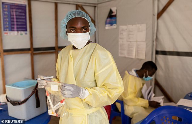 Christian Musema, a laboratory nurse, verifies samples taken from a child declared a suspected case of monkeypox virus in DRC on July 19. Children make up 10% of mortalities