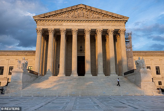 A security guard walks down the steps of the US Supreme Court in DC on July 19, 2024