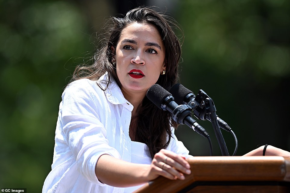 The camera then pans back to AOC who was sitting on stage with her legs spread and dancing to the drum beat, trying to appear unbothered by the interruption. One woman could also be heard repeatedly calling AOC a 'sellout.'