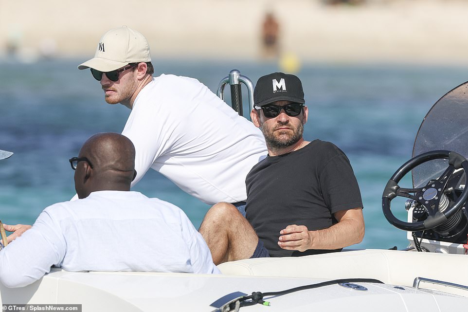 Maguire, 49, sported a black baseball cap, matching t-shirt and shorts for their latest excursion