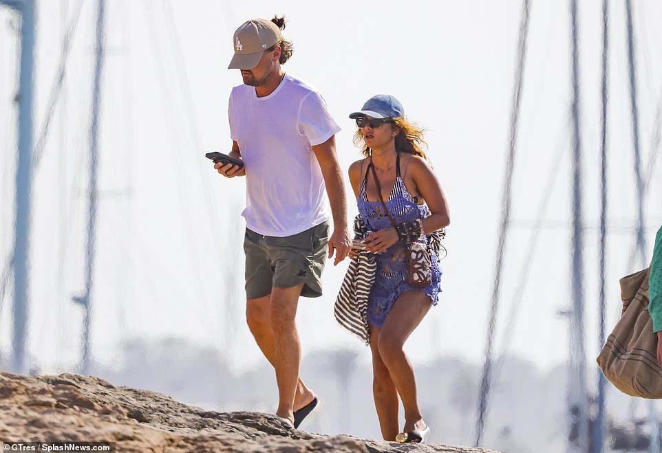 While preparing to cruise around the island with a large group of friends, the couple, who were first romantically linked in August 2023, stuck close together as they walked side-by-side on some rocky terrain