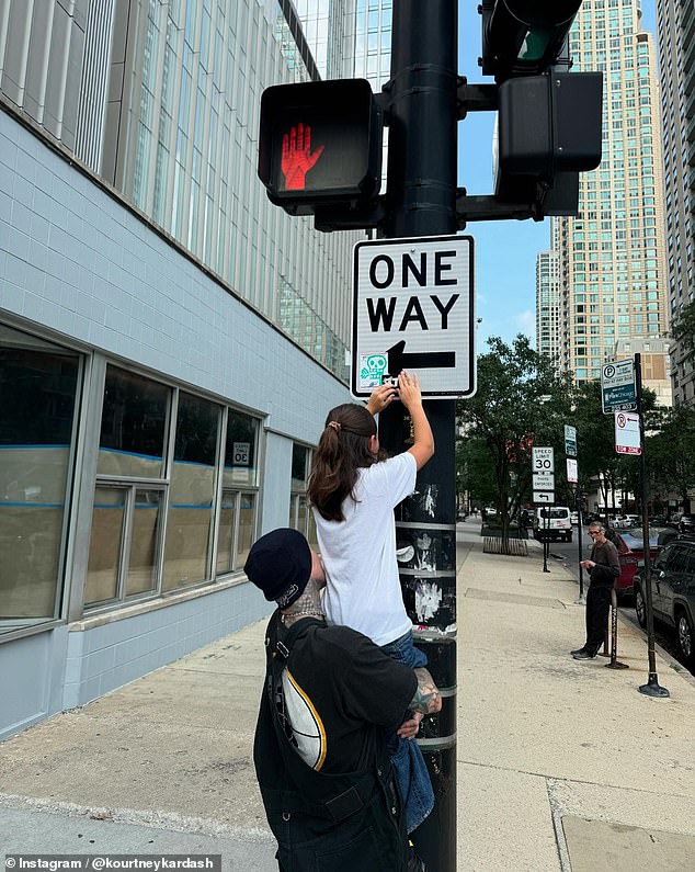 There was a special place for Penelope, 12, who was featured in a cute photo of Travis holding her up to put a sticker on a street sign