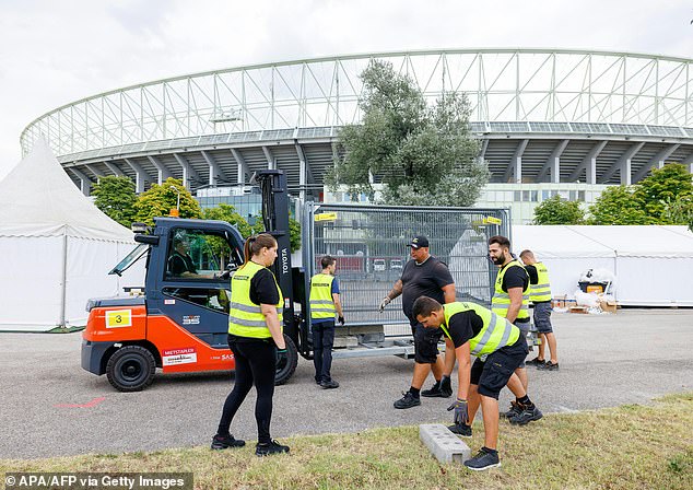 Workers remove barriers in front of the Ernst Happel Stadium in Vienna, Austria after the concerts were cancelled