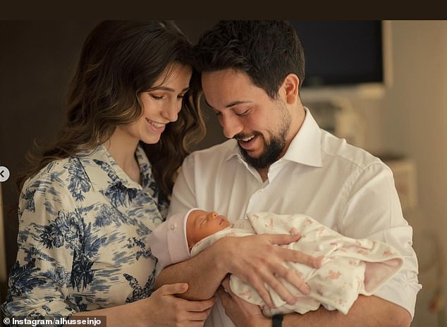 In the second photograph shared to Instagram, the proud parents looked at their newborn daughter in awe