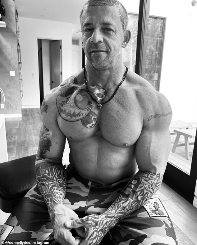 The dentist, 51, strikes an imposing figure with his extensive body and scalp tattoos, rippling muscles and penchant for A-list events