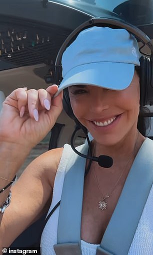 The brunette beauty donned a white tank top, a matching cap, and a pair of headphones