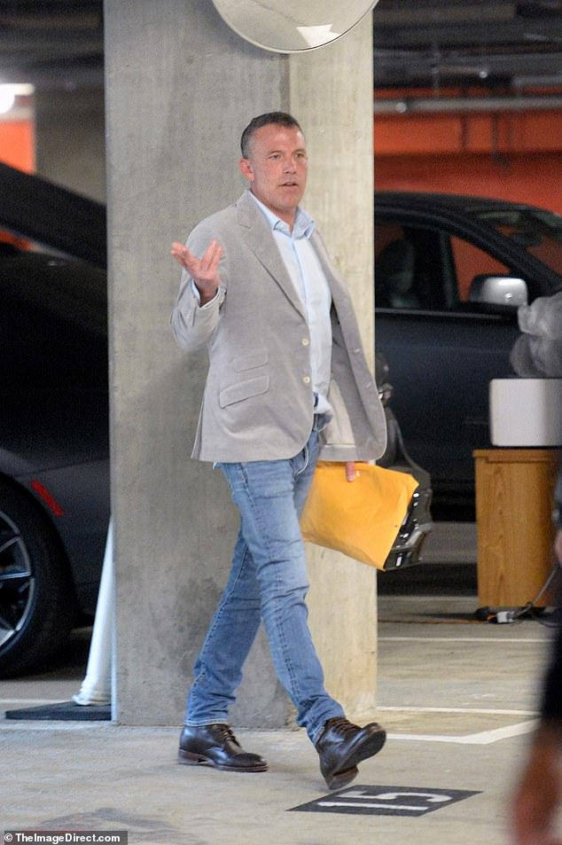 The Air actor-director was clad in a gray sport coat over a light blue button-up shirt with blue jeans and black boots