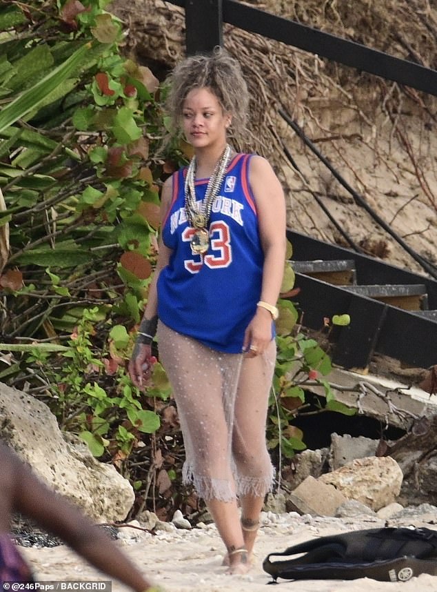 The singer slipped into a sheer jewelled skirt and a basketball jersey as she headed to the beach to soak up the sunshine