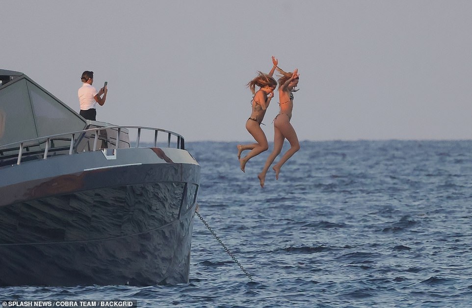 Rita had one of the crew snap a photograph of her jumping off the yacht with one of her pals