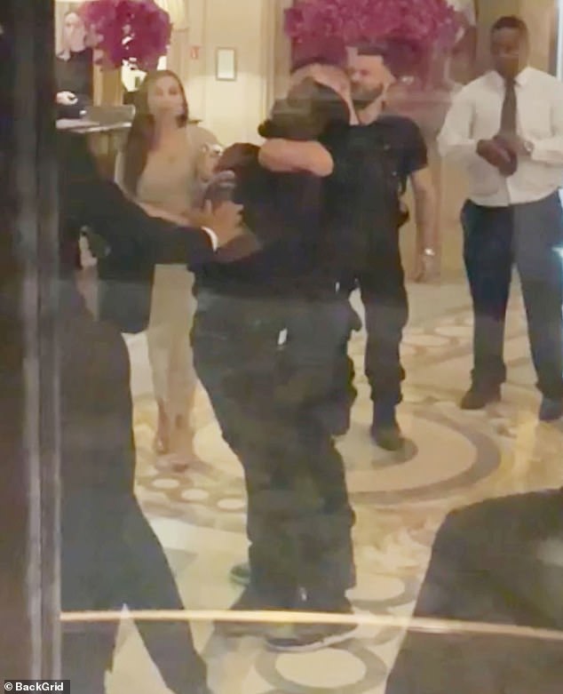 Police detain another man in the hotel, presumed to be one of the guards Scott was fighting with