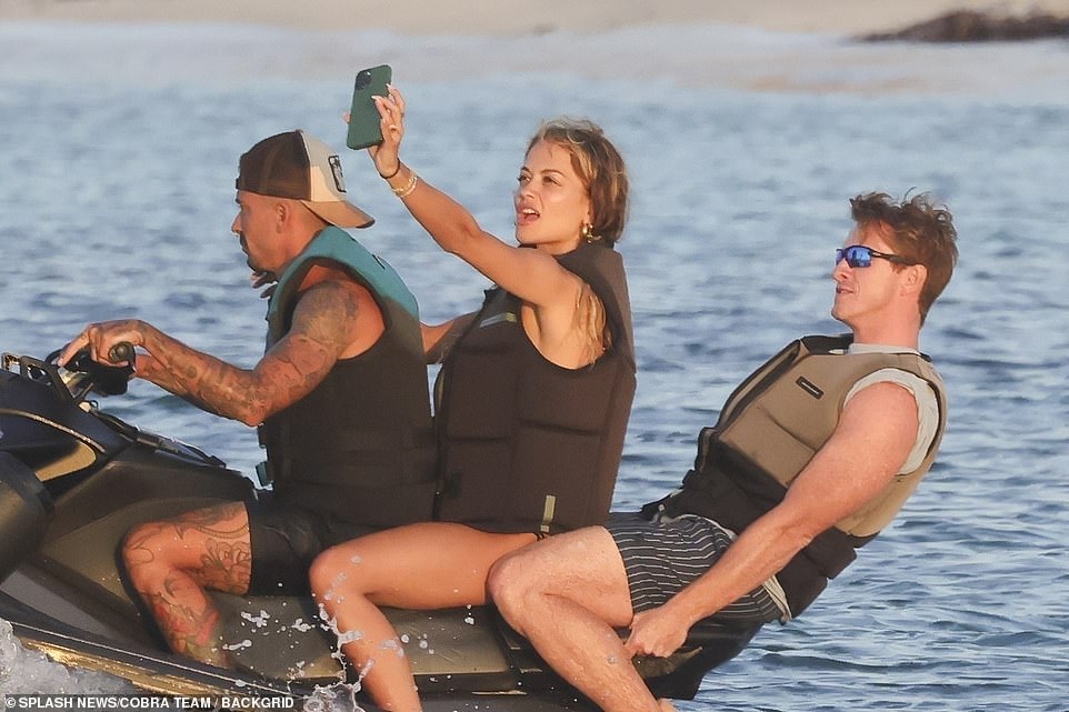 Her pals clung onto the boat as they jetted across the sea