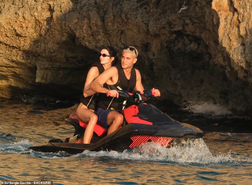 The duo rode a black and red jet ski