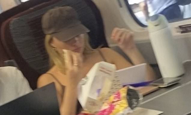 Hollywood A-list star looks unrecognisable as she tucks into a Pret sandwich on train to